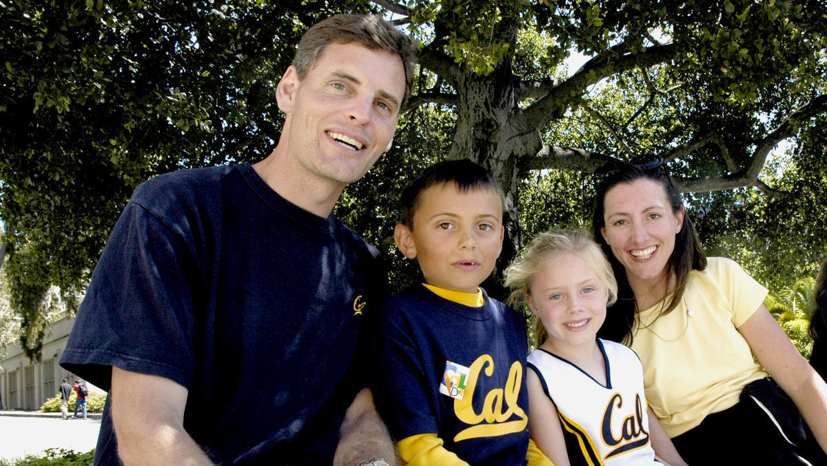 A family sitting on a bench on CalDay Credit Bonnie Azab Powell UC Berkeley